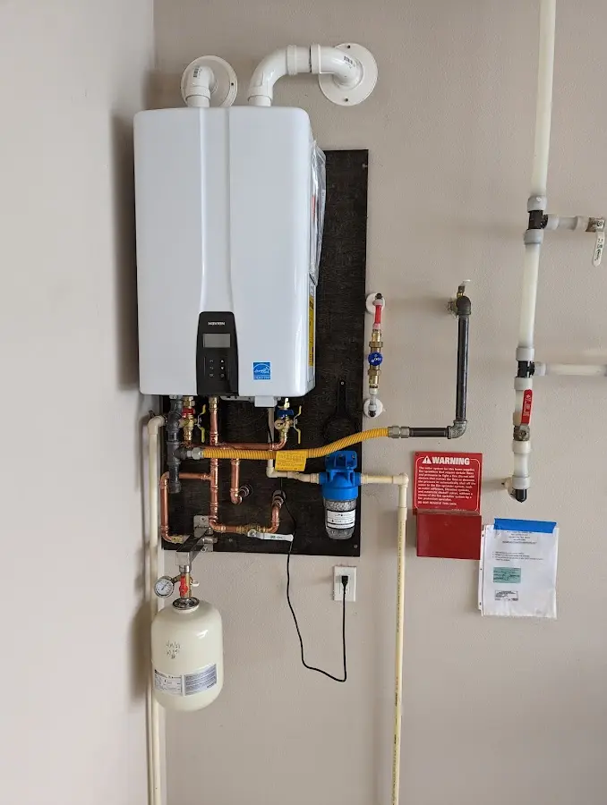 Professional plumber installing copper piping in a Tigard home